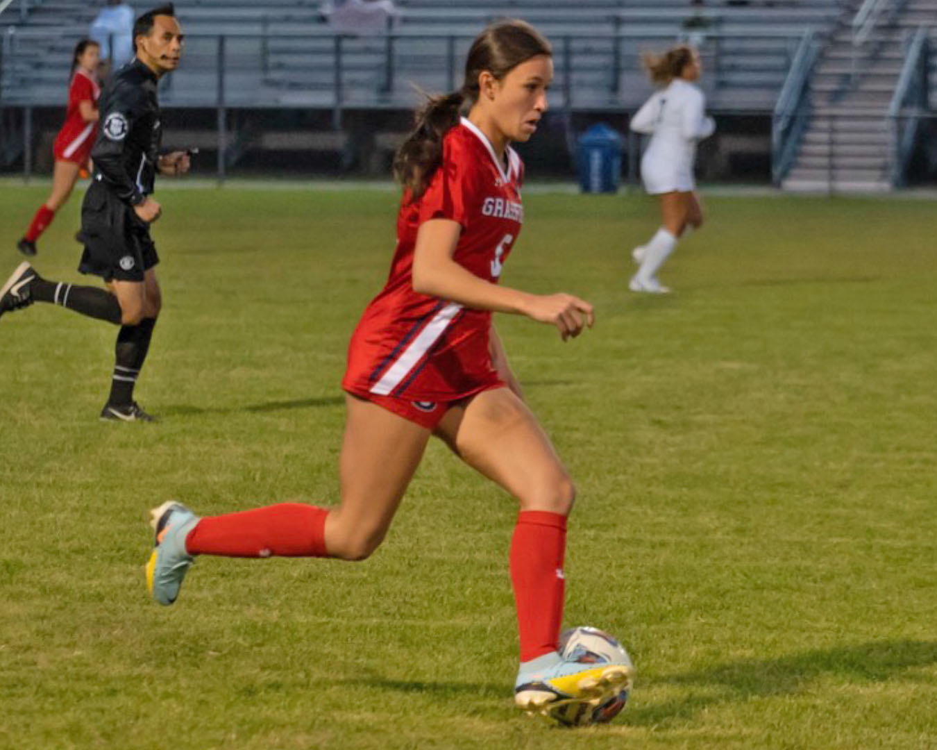 ciera frick drives towards goal with the ball